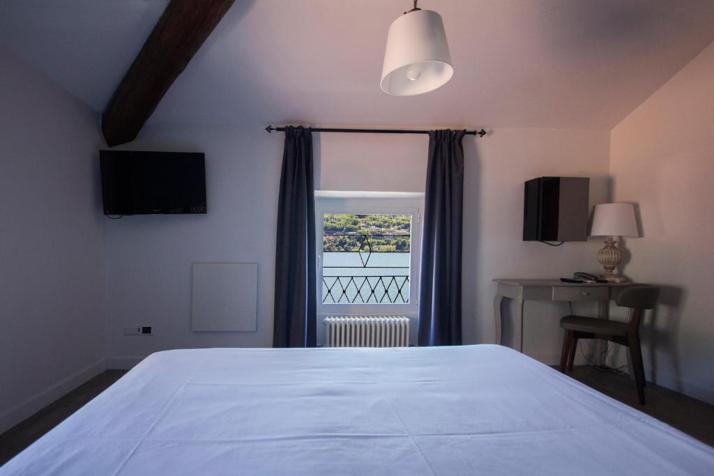 Postel nebo postele na pokoji v ubytování Hotel Orso Bruno