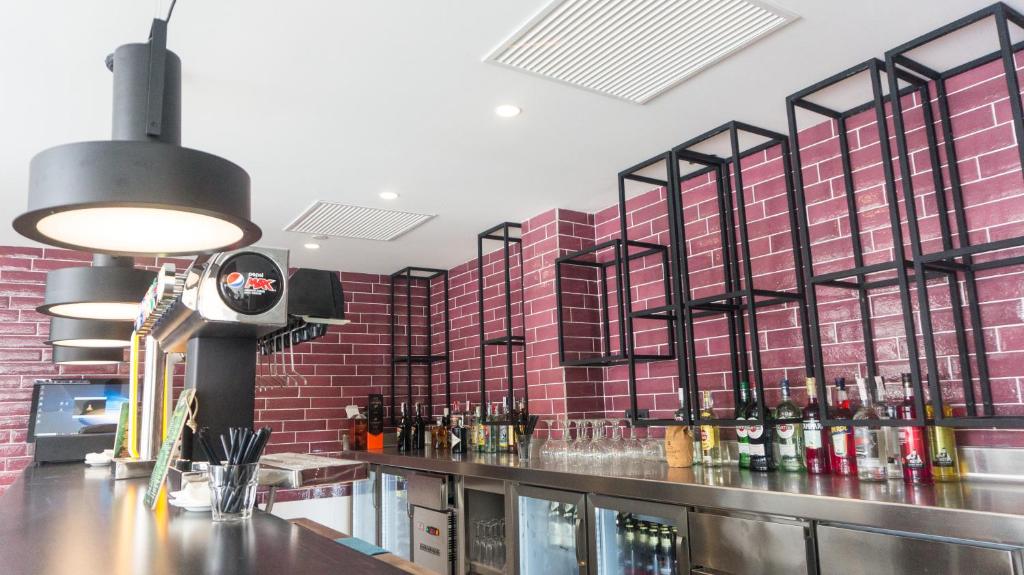 a bar in a restaurant with red brick walls at Hotel Paradiso Garden in Playa de Palma