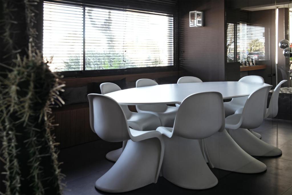 a conference room with a white table and chairs at Hotel Salus in Pescara
