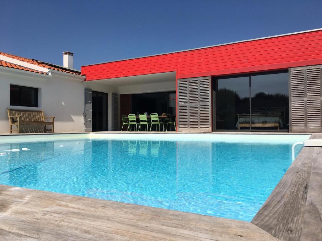 a swimming pool in front of a house at Les Naiades in Dolus d'Oléron