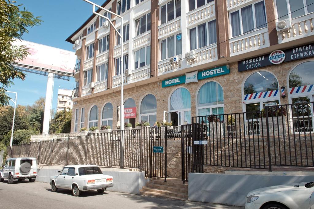 a white car parked in front of a building at Station in Adler