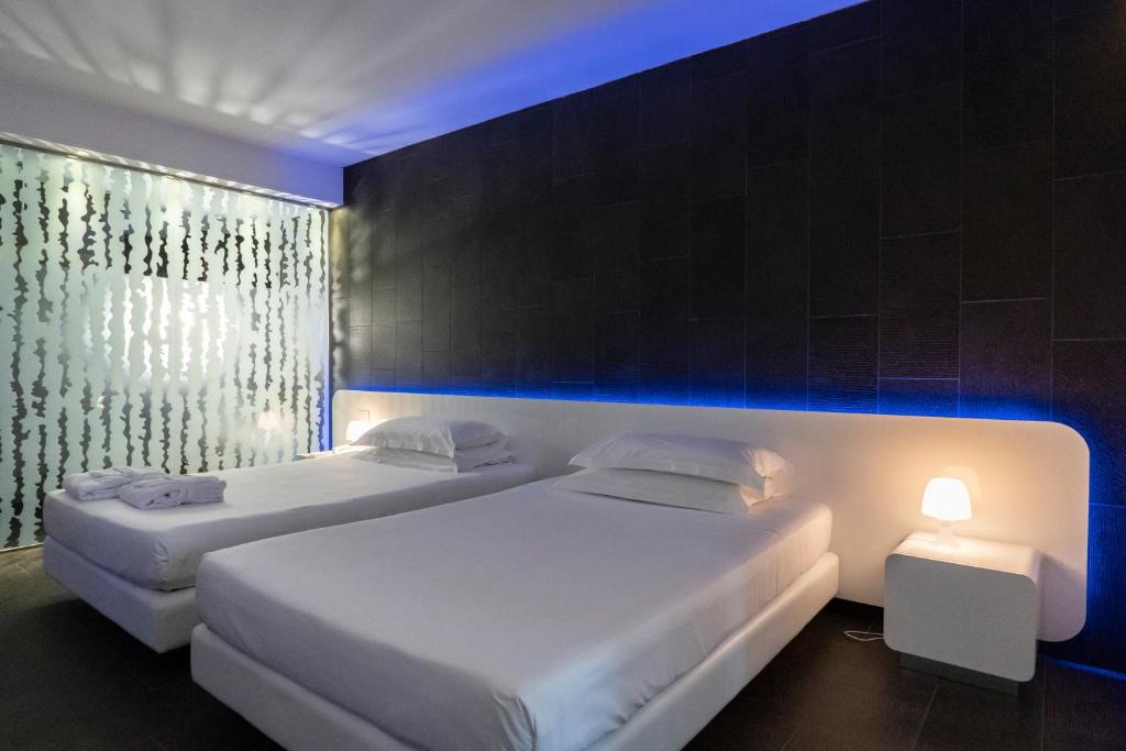 Postel nebo postele na pokoji v ubytování A Point Porto Ercole Resort & Spa