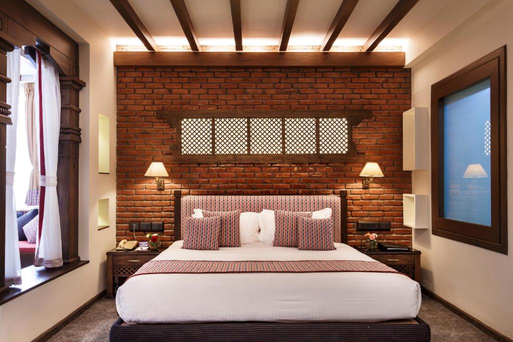 Postel nebo postele na pokoji v ubytování Royal Singi Hotel