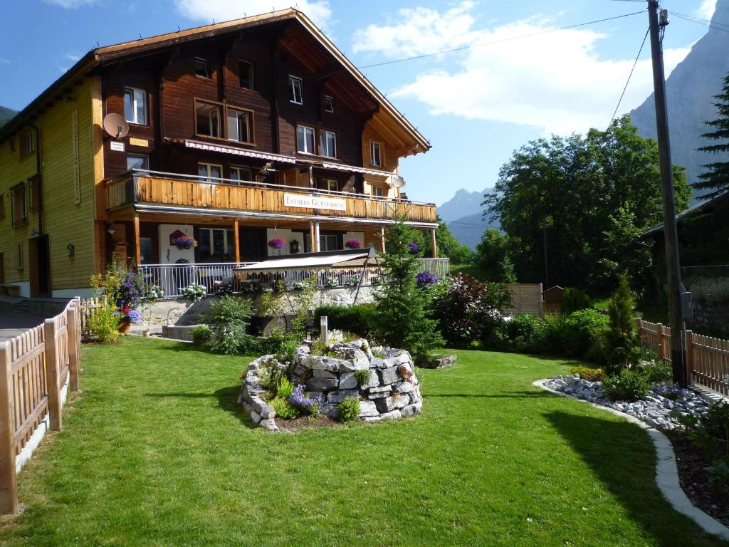 a house with a garden in front of it at Esthers Guesthouse in Gimmelwald