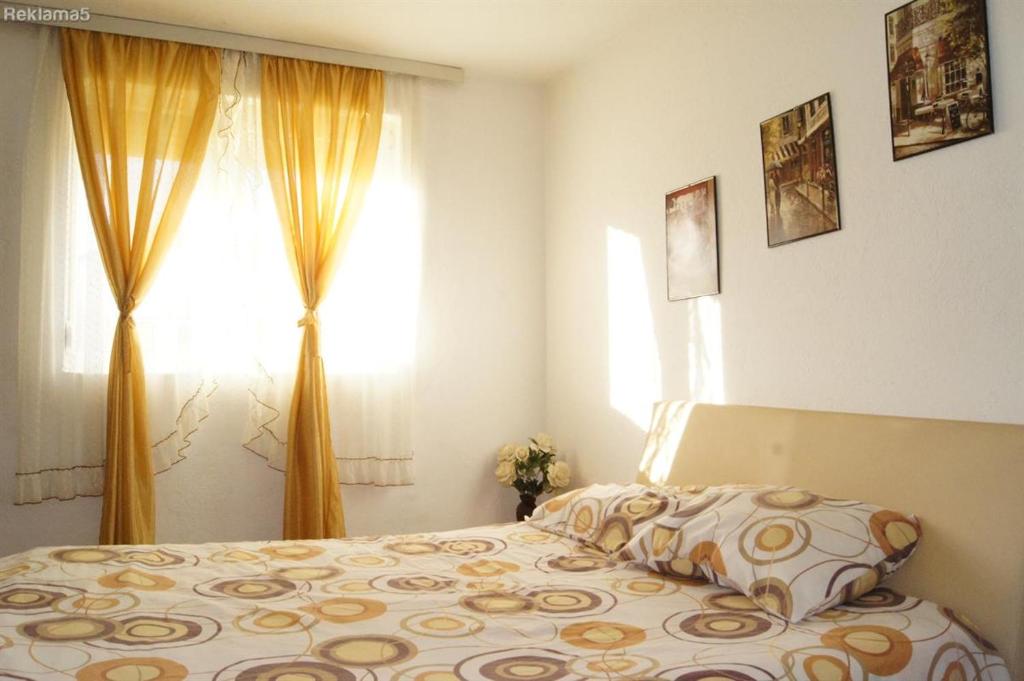 a bedroom with a bed and a window at Petrograd in Bitola