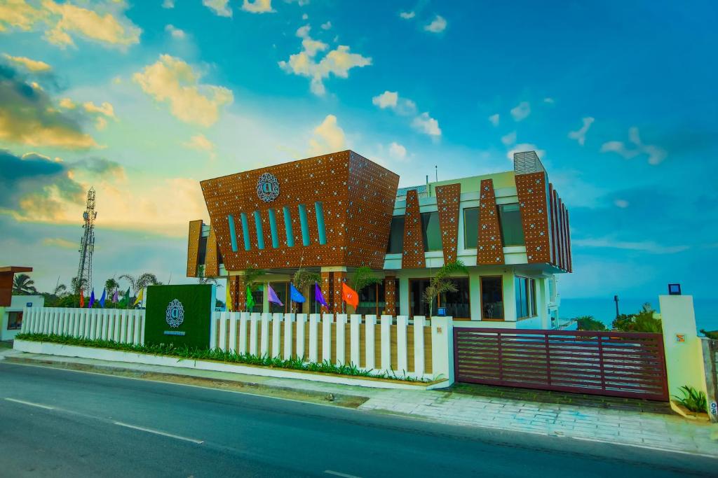 a building with a fence in front of a street at Annai Resorts & Spa in Kanyakumari