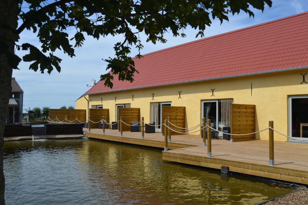 a building on a dock next to a body of water at B&B 't Koolhof in Nieuwpoort