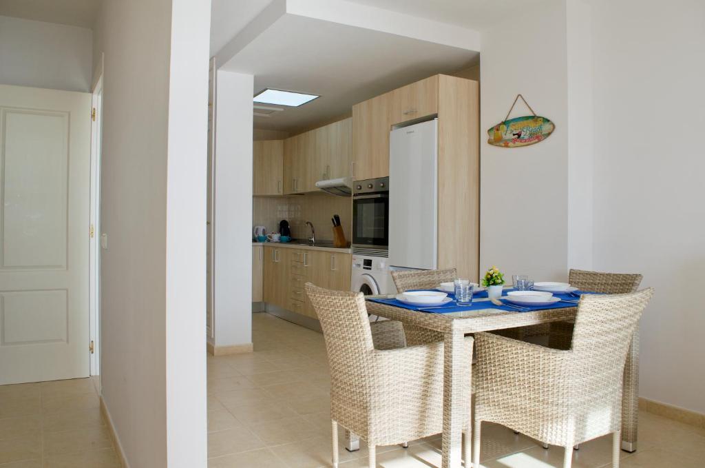 a kitchen with a table and chairs in a room at Residencial Playa Paraiso in Costa Calma