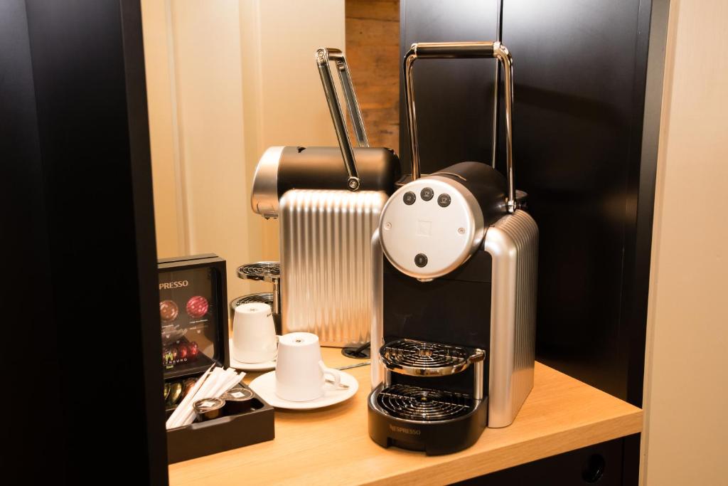 a coffee maker sitting on top of a table at Hotel Restaurant Falkenburg in St. Gallen