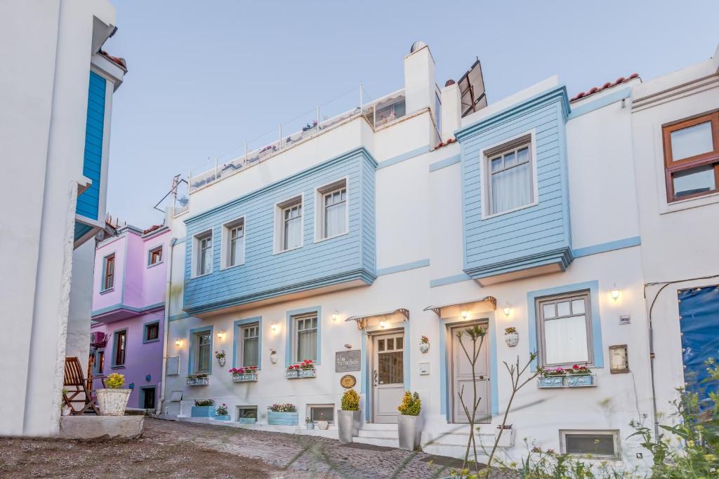 a row of colourful houses in a street at Ela Tenedos Hotel - Special Category in Bozcaada