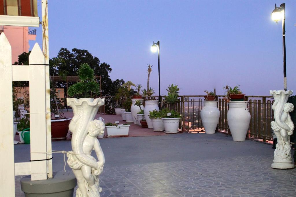 a group of white vases sitting on a balcony at Apartment Terrazza Greca in Agrigento