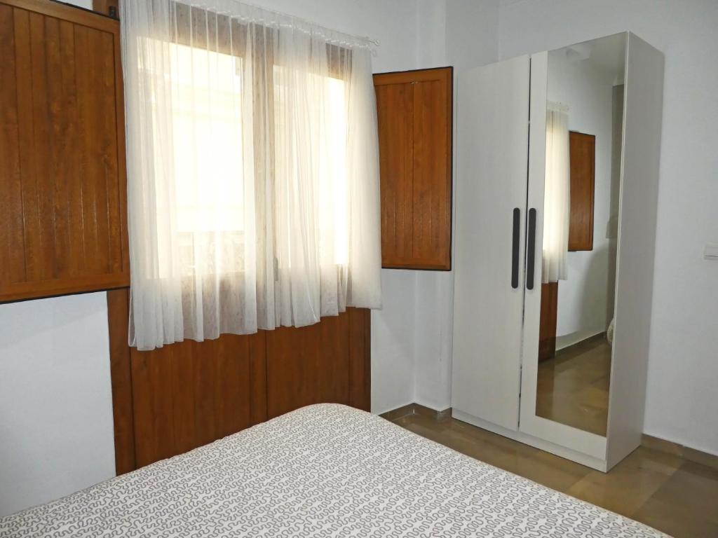 A bed or beds in a room at Apartamentos Catedral Plaza 3000