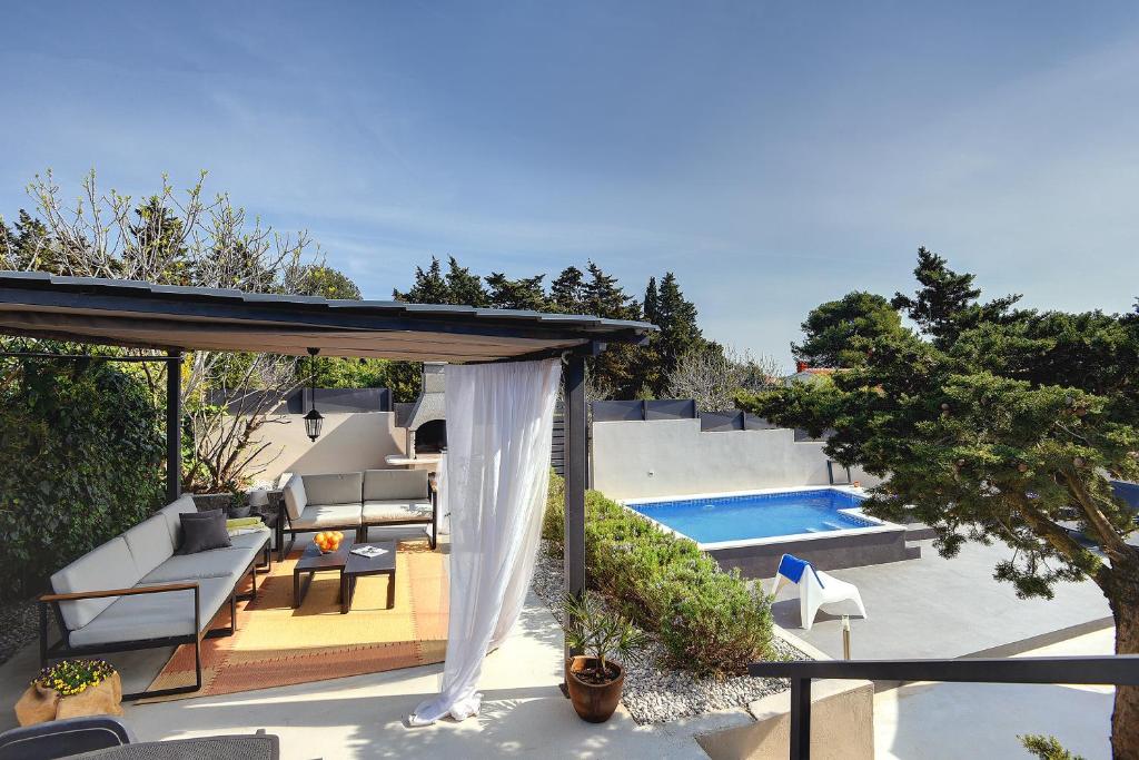 a patio with a gazebo and a swimming pool at House Zoya in Ližnjan