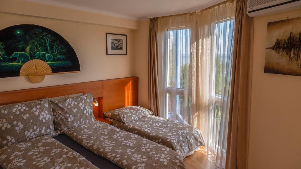 Postel nebo postele na pokoji v ubytování Aart Apartman