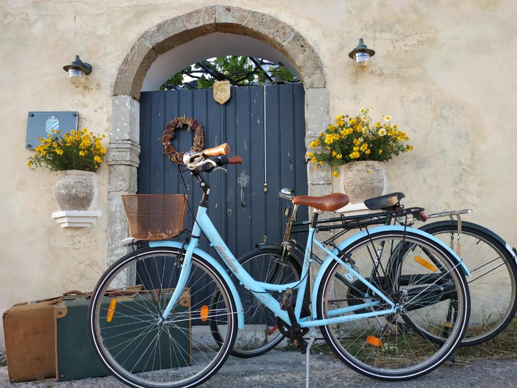 a blue bike parked in front of a door at DonQuihotel Chalet in Karvounádhes
