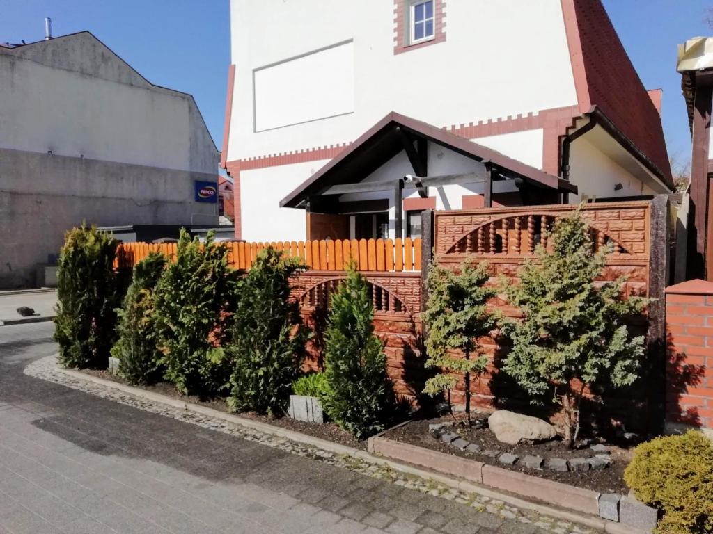 a row of christmas trees in front of a house at Pokoje Gościnne POD DELFINKAMI in Ustka