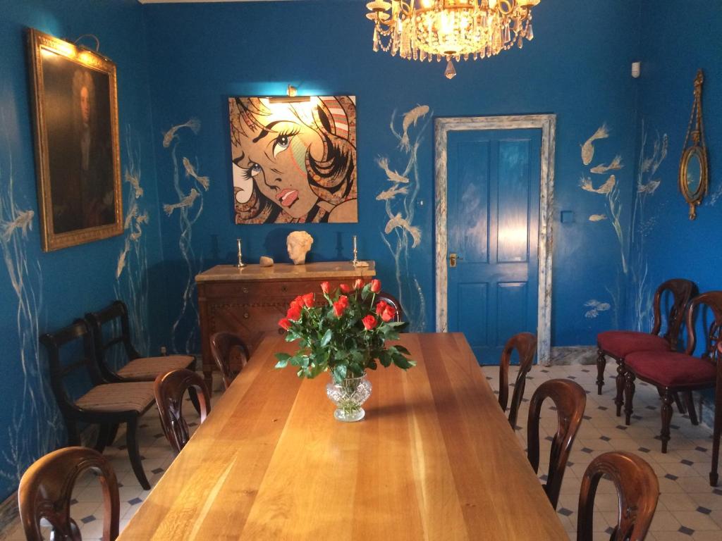 a dining room with a wooden table with a vase of flowers at Victoria Spa Lodge in Stratford-upon-Avon