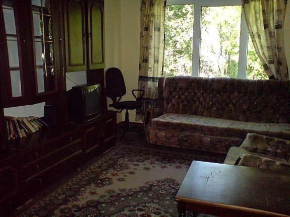 a living room with a couch and a tv at Lattino pietura in Rīga