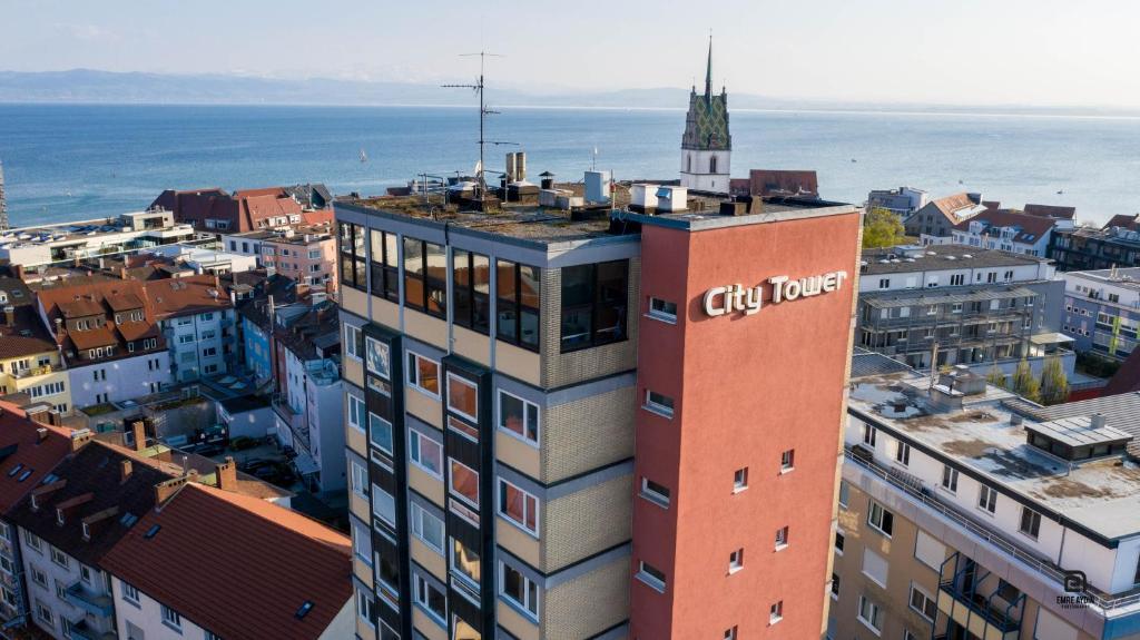 a tall building with a city tower on top of it at Skyhostel Friedrichshafen in Friedrichshafen