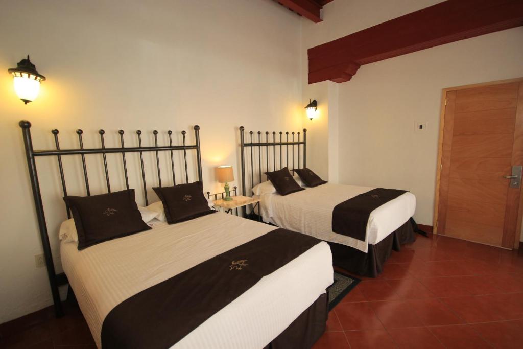 Postel nebo postele na pokoji v ubytování Hotel Santa Regina