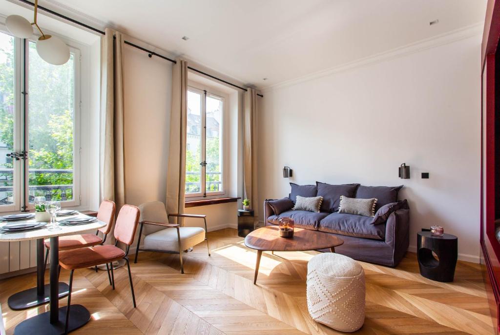 a living room with a couch and a table at CMG Galeries Lafayette / Madeleine D in Paris