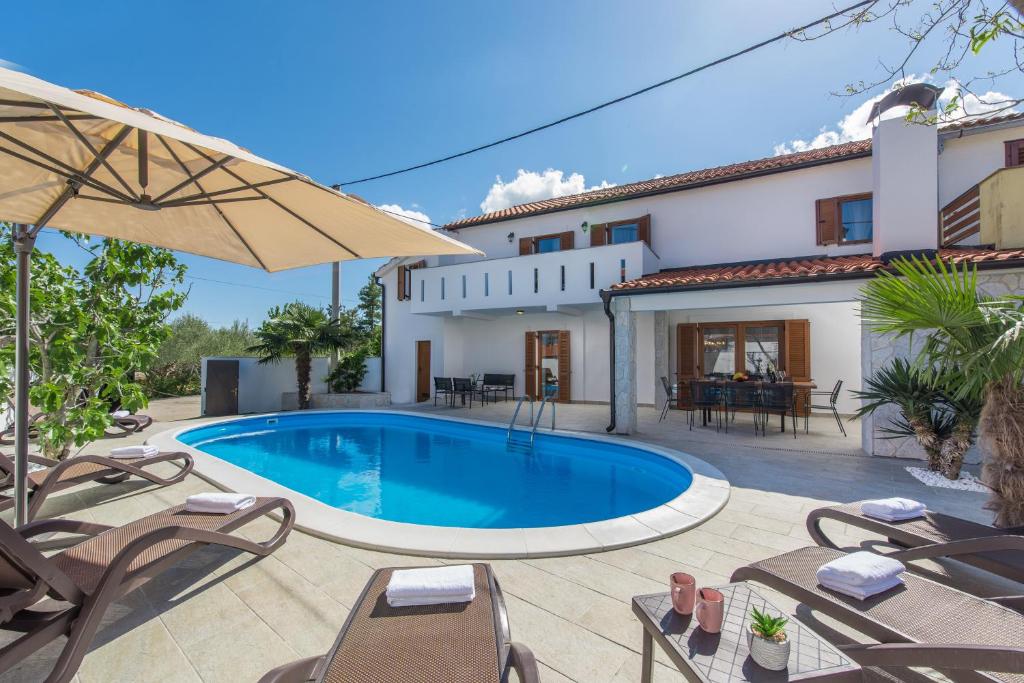 een villa met zwembad voor een huis bij Villa Zlata in Krk