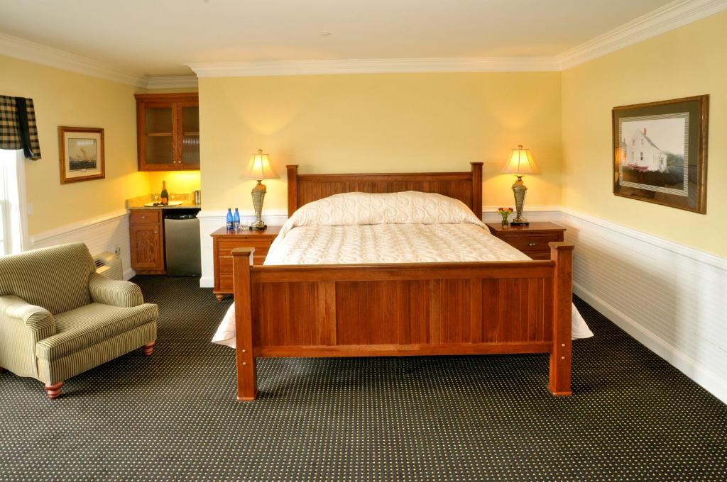 a bedroom with a large bed and a chair at Smithfield Station in Smithfield