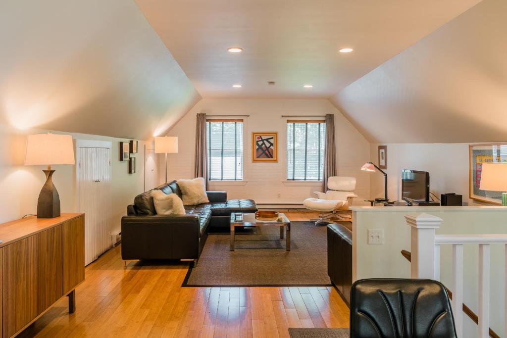 a living room with a couch and a table at The Carriage House Loft in Kingston