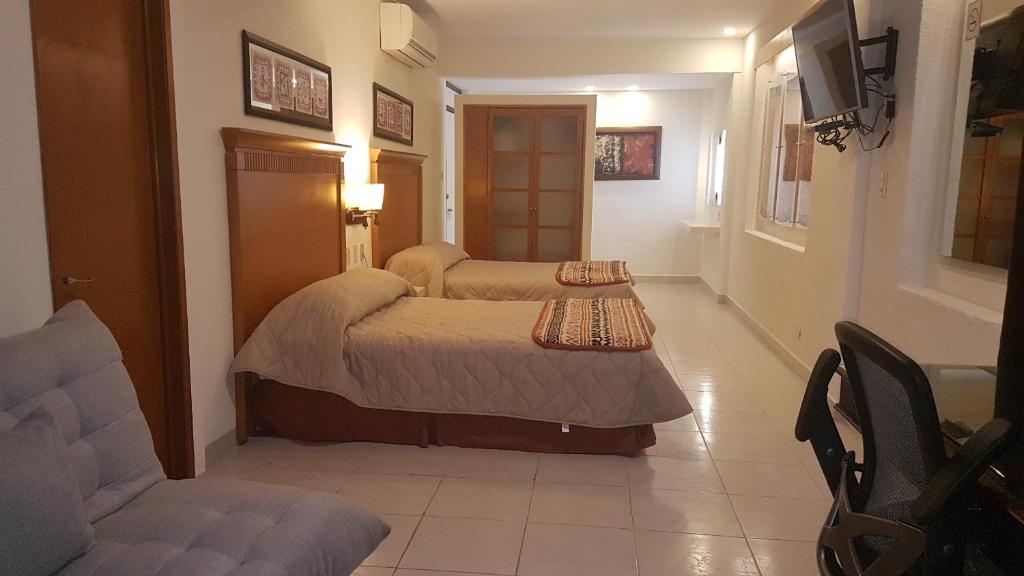 Postel nebo postele na pokoji v ubytování Hotel y Suites Nader