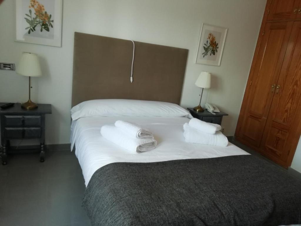 a bedroom with a bed with towels on it at El Sueño del Infante in Guadalajara