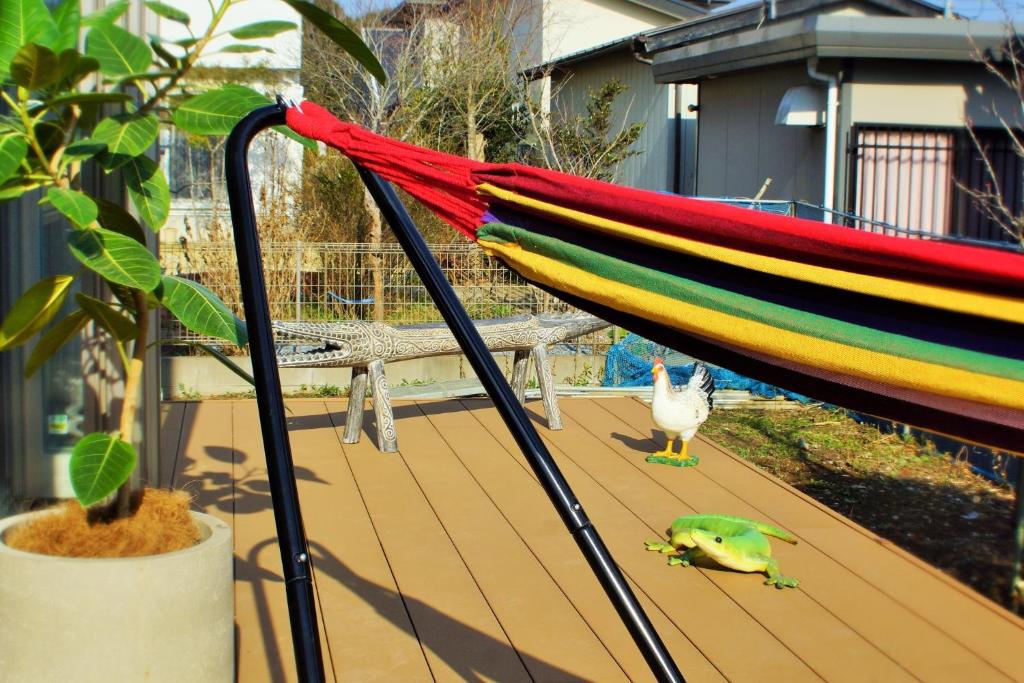 a colorful umbrella and a frog on a deck at BALLAD HOUSE / Vacation STAY 31548 in Yachimata