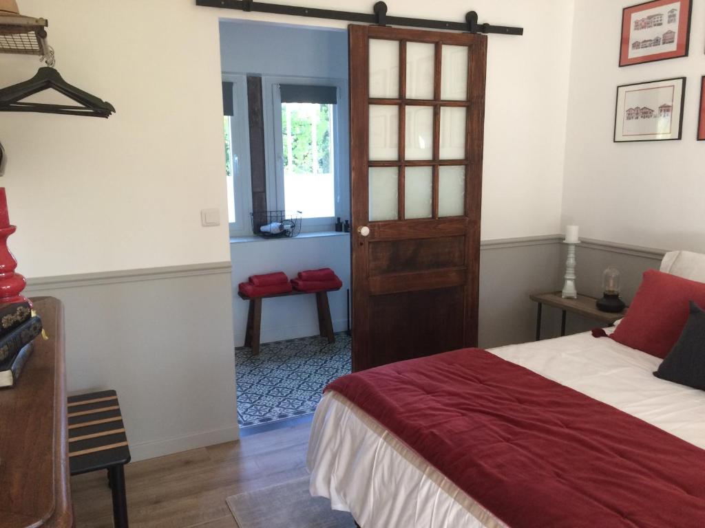 a bedroom with a bed and a door at VILLA XARAN ERDIAN in Espelette