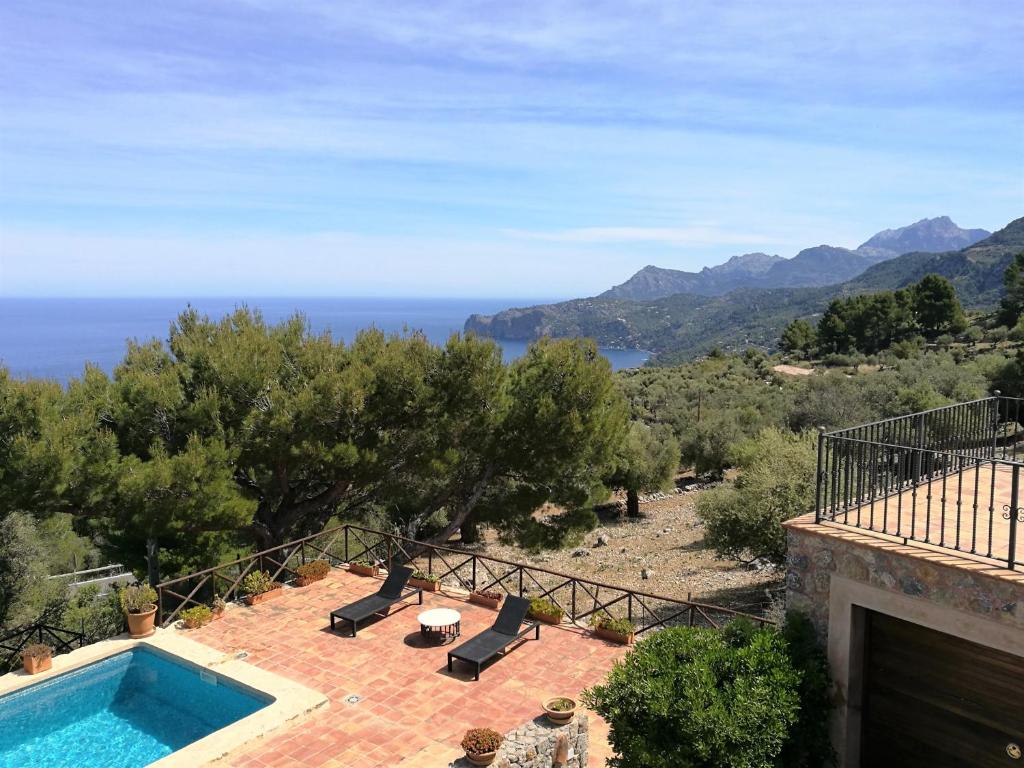 a villa with a swimming pool and a view of the ocean at La Galera Deià in Deia