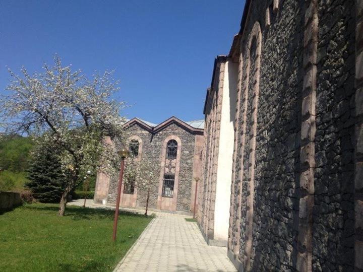 a large brick building with a pathway in front of it at Anush restaurant/hotel in Vanadzor