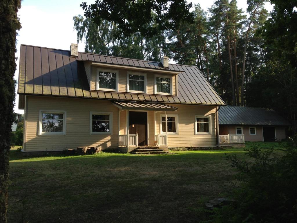 a house with a metal roof on a yard at Sae Hostel in Võsu