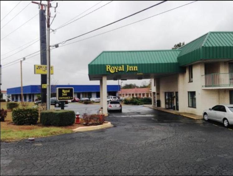a royal inn parking lot with a car parked in front at Royal Inn Columbia/Fort Jackson in Columbia
