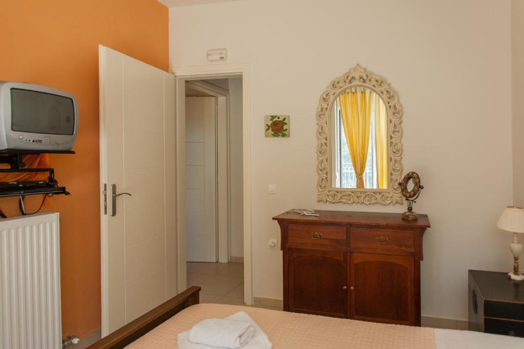 A television and/or entertainment centre at Cretamos Seaside Villas