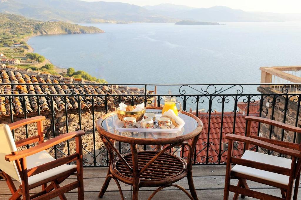 a table with a tray of food on a balcony at Melpomeni Villa in Mythimna