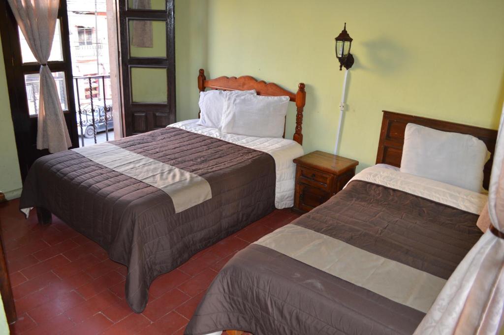 Postel nebo postele na pokoji v ubytování Hotel Dos Rios