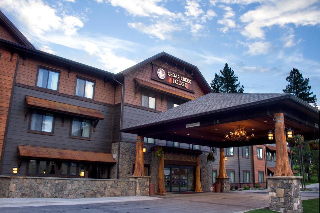 a building with a sign that reads guest lodge at Cedar Creek Lodge & Conference Center in Columbia Falls