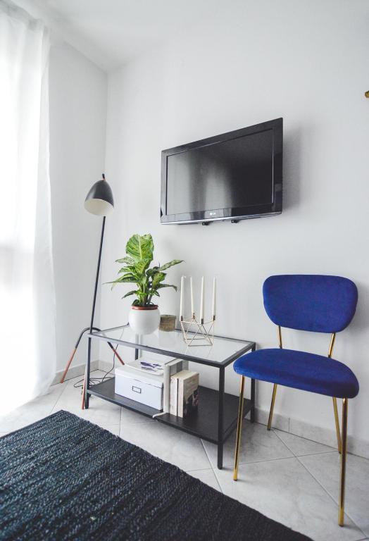 a living room with a blue chair and a table at Apartments Lucija in Zadar