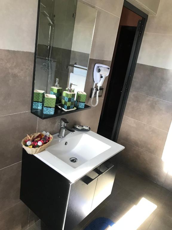 a bathroom with a sink and a mirror at Studiotel Afoud in Agadir