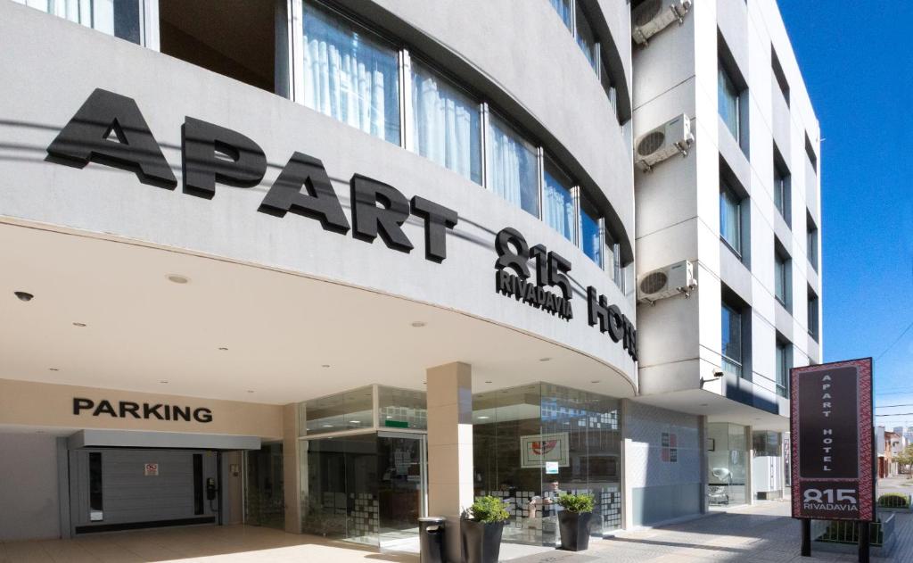 a large building with a sign on the side of it at Apart Hotel Rivadavia 815 in Neuquén