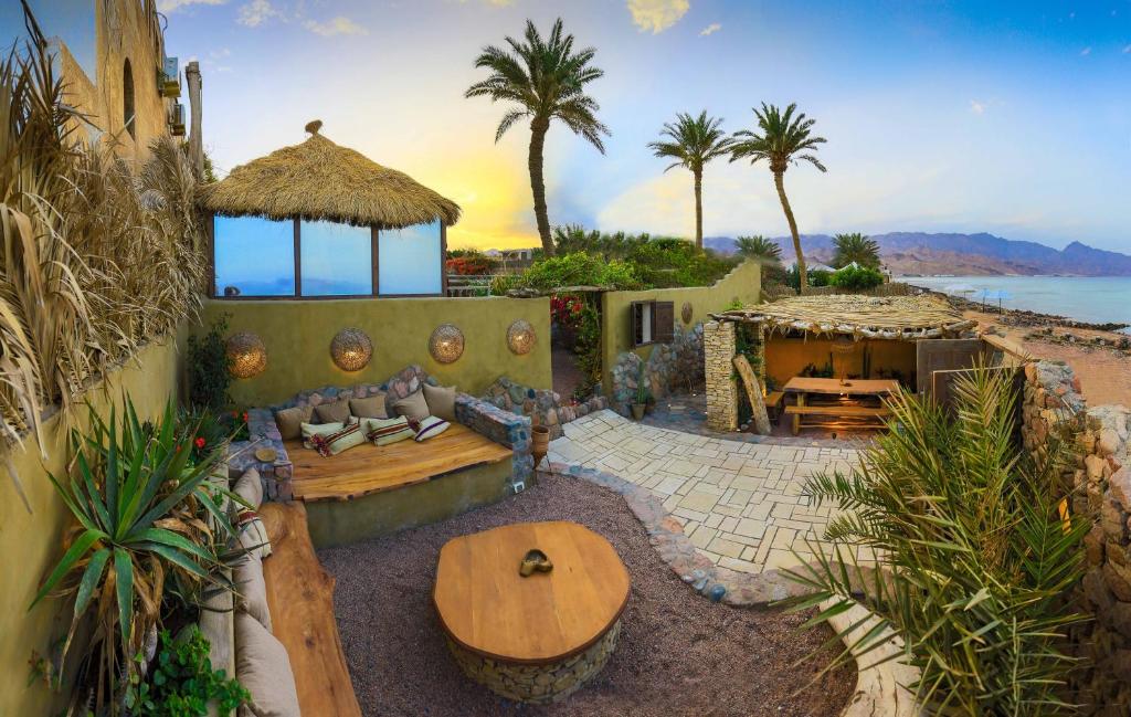 a living room with a table and a view of the ocean at Beit Theresa in Dahab