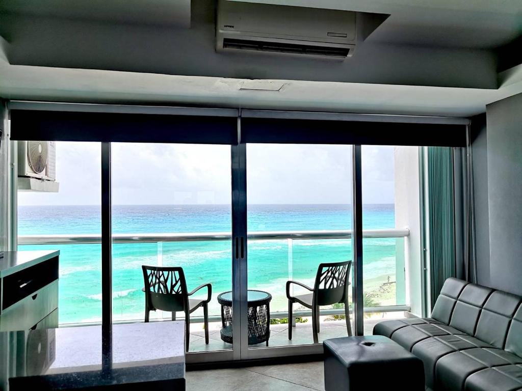 a living room with a view of the ocean at Cancun, Ocean Dream, Beautiful Aparment, Heart of the Hotel Zone in Cancún