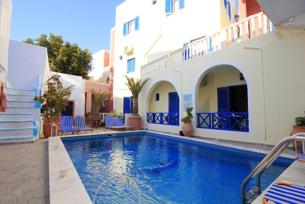 a villa with a swimming pool in a resort at Hotel Leta in Fira