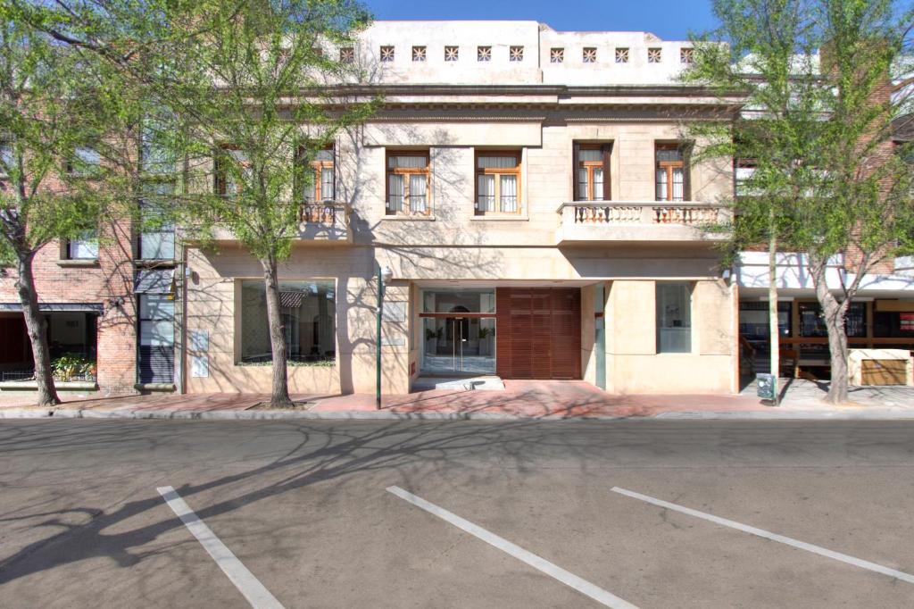 an empty parking lot in front of a building at San Isidro Plaza Hotel in San Isidro