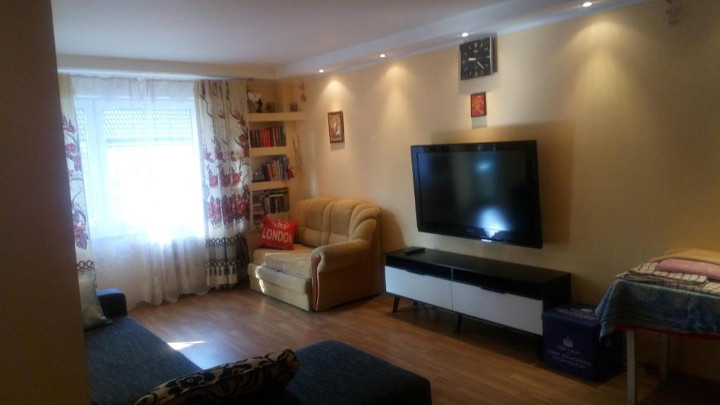a living room with a large flat screen tv at Brivibas Avenue Apartment in Jūrmala
