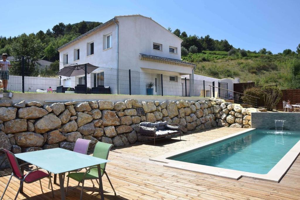 a house and a pool with a table and chairs at LA KALICIA in Pierrelongue