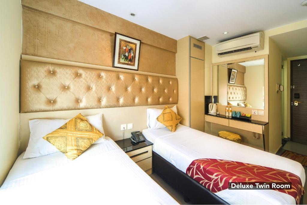 Postel nebo postele na pokoji v ubytování Sandpiper Hotel Singapore